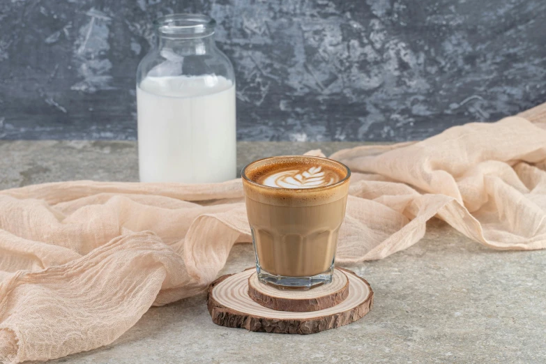 a glass of drink sitting on top of a piece of wood