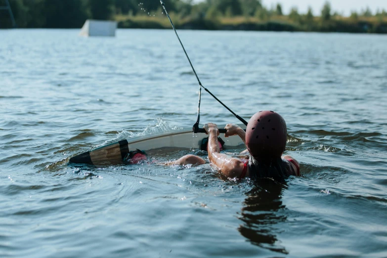 a man on a surfboard floats in the water