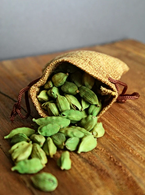 green beanes are laying on a brown wooden board