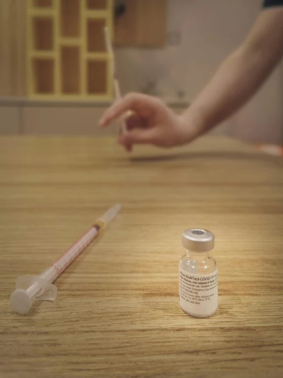 small medicine bottle next to the medicine needle