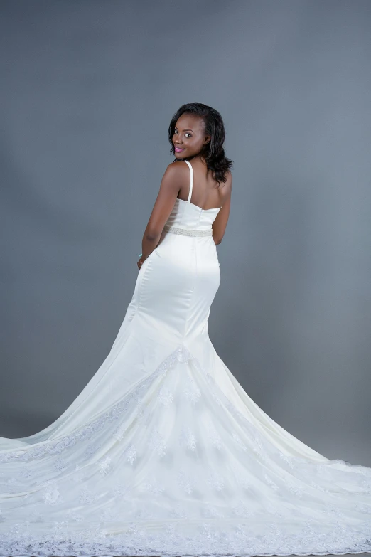 an african woman is posing in a wedding dress