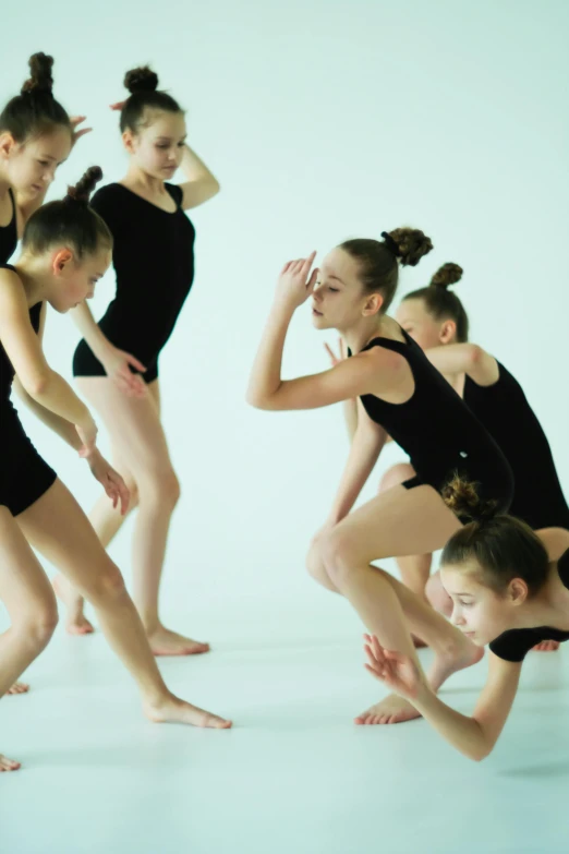 several young ladies in leotards posing in a group