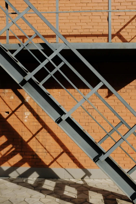 there is a brick wall with a metal stair case