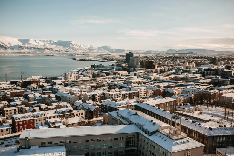 the view of a large city with snow covered rooftops