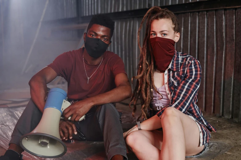 a woman and man with long hair and face masks