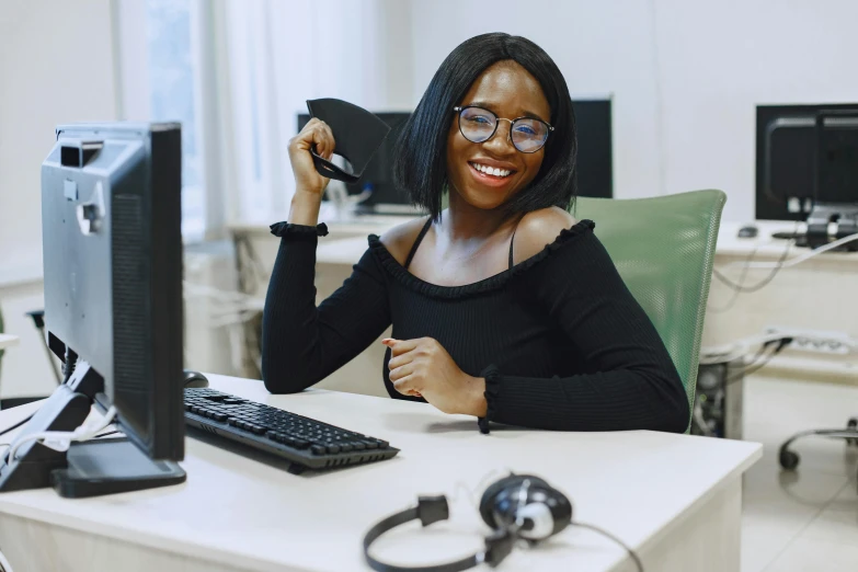 a smiling black woman in her office posing for a po