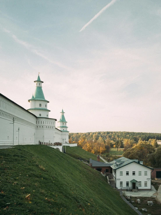 a building with a steeple on top near other buildings