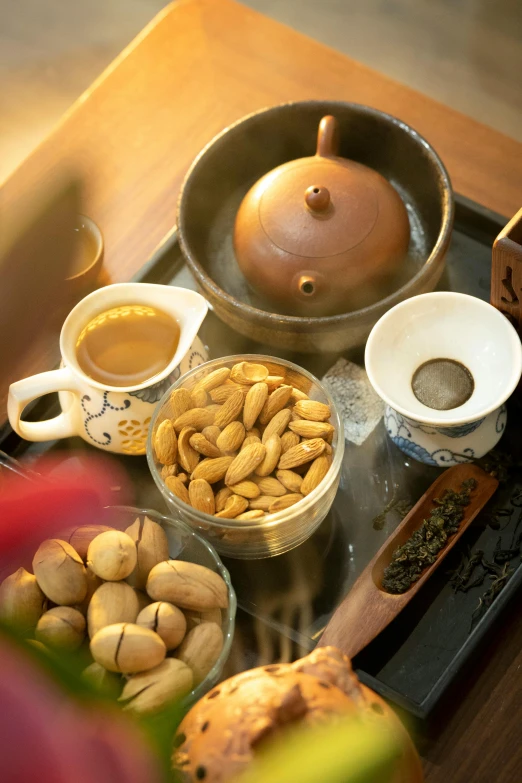a tray with various bowls filled with nuts and other items