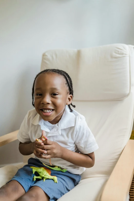 a  sitting on a chair and smiling