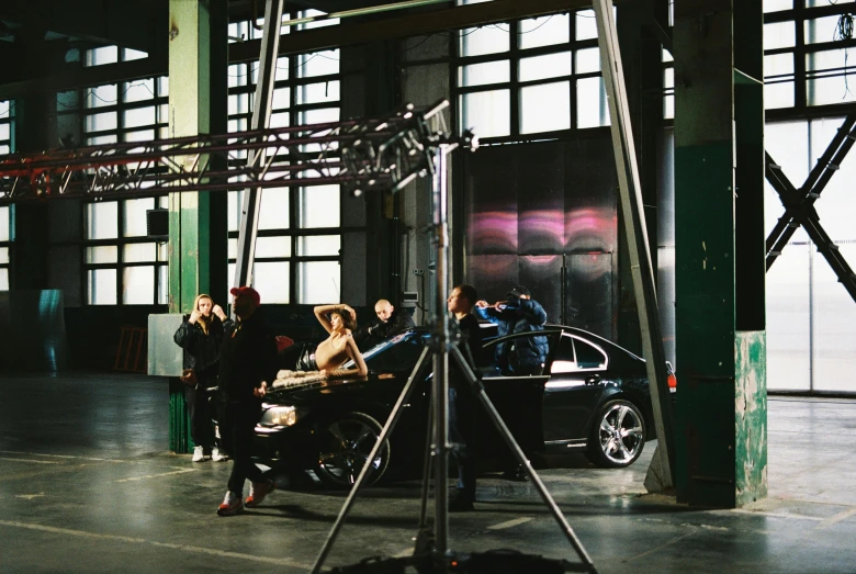 a car with people taking pictures in front of it