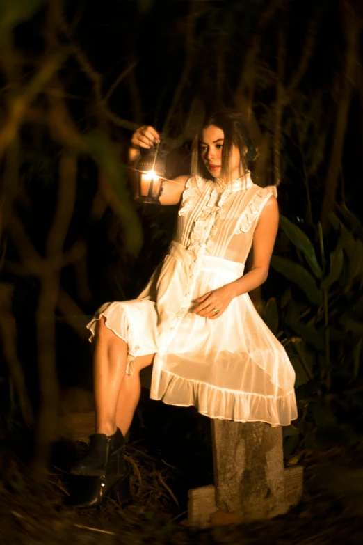 a woman is sitting down while holding a lite