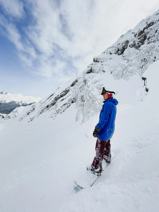 a man in a blue coat is skiing in the snow