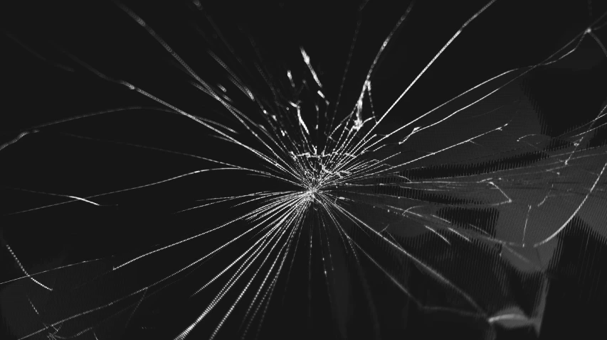 a broken glass with white streaks on black background