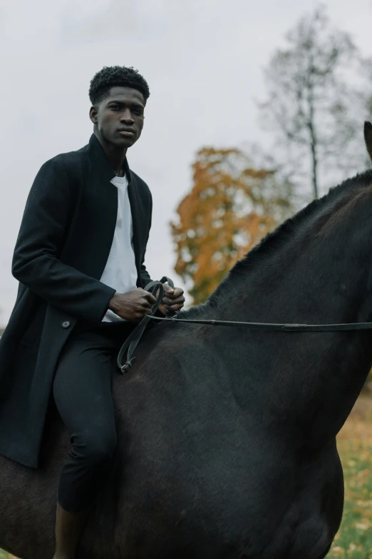 an african american man riding on the back of a black horse