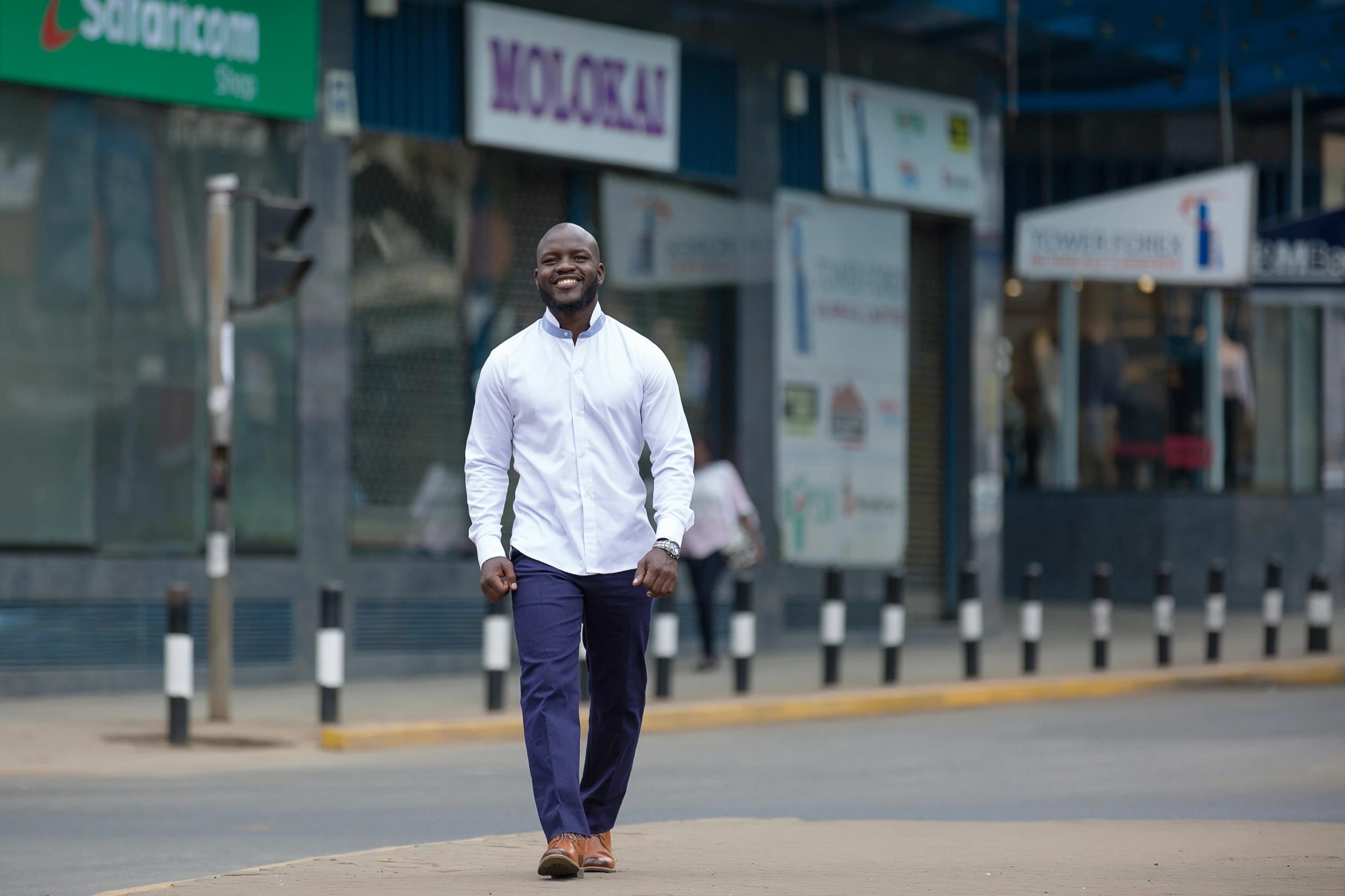 a man walking down the street in front of an empty store