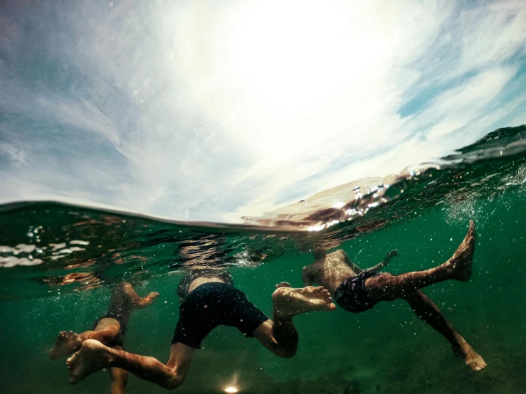 two s swimming in the ocean under water