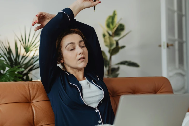 a woman sitting on a couch with her head in her hands