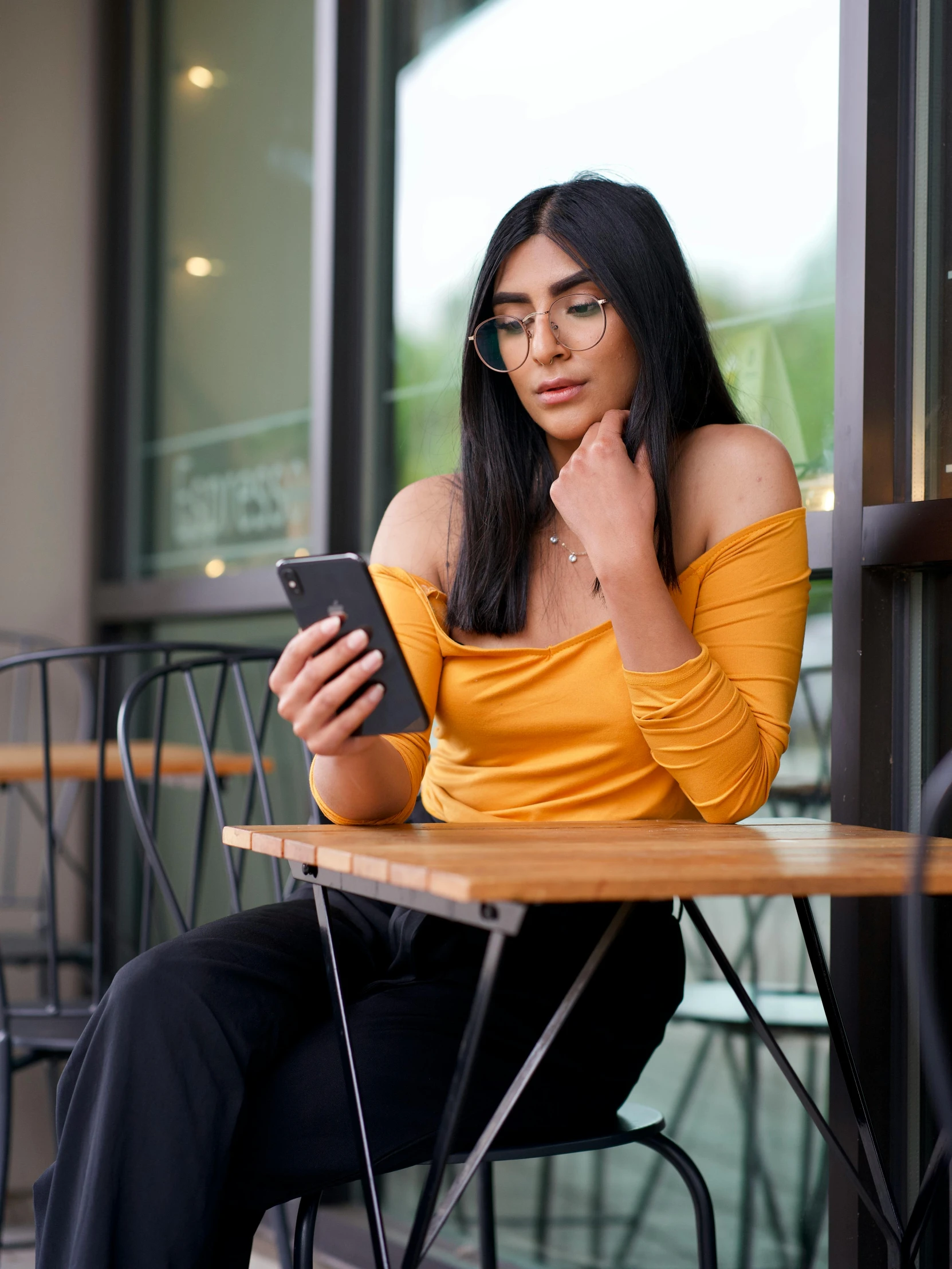 a woman is looking at her phone on the table