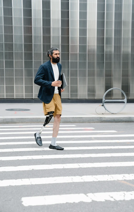 a man walking across a street wearing a black jacket