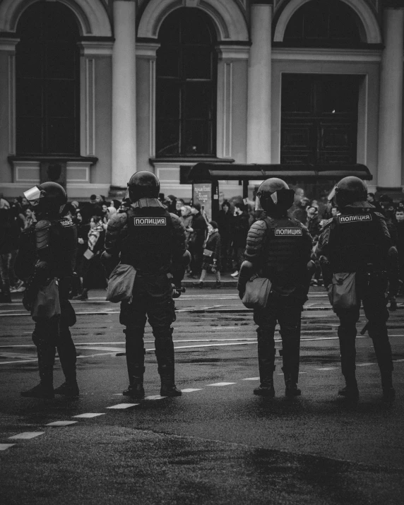 a bunch of policemen that are standing in the street