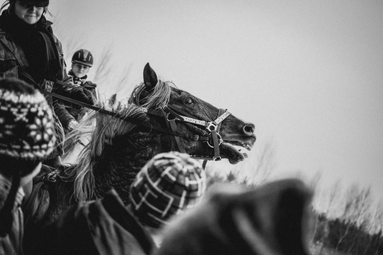 a black and white image of a person riding on the back of a horse