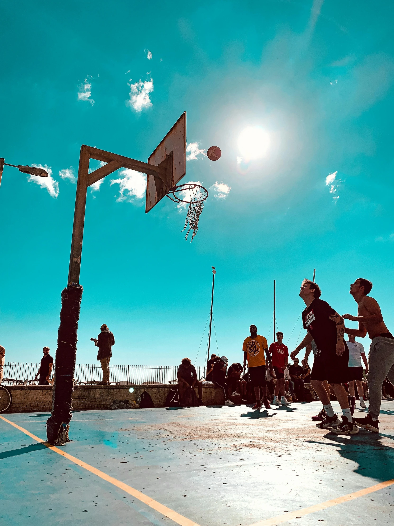 a basketball court with people playing basketball on it