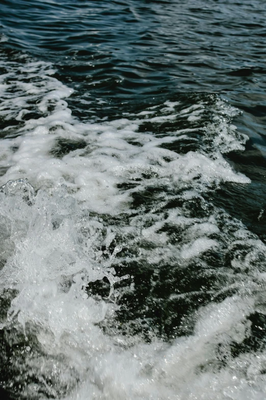 a black and white po of water coming towards a boat