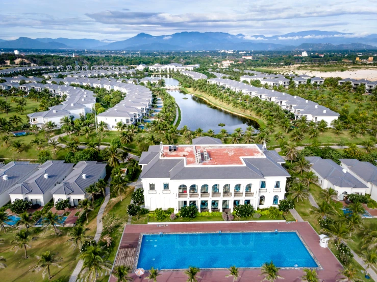 an aerial po of some buildings next to a body of water