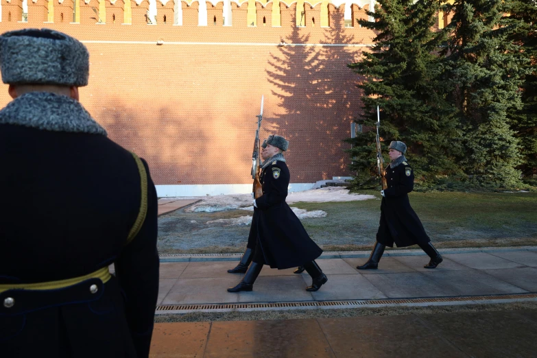 two army officers standing on a sidewalk in formation