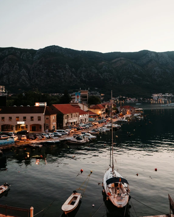 boats at a pier in front of some buildings