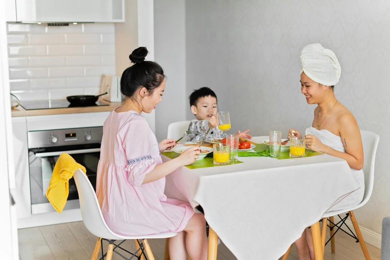 a group of people sitting at a table eating food