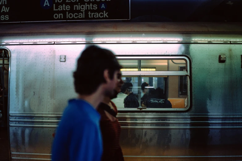 a man stands in the doorway of a moving subway train