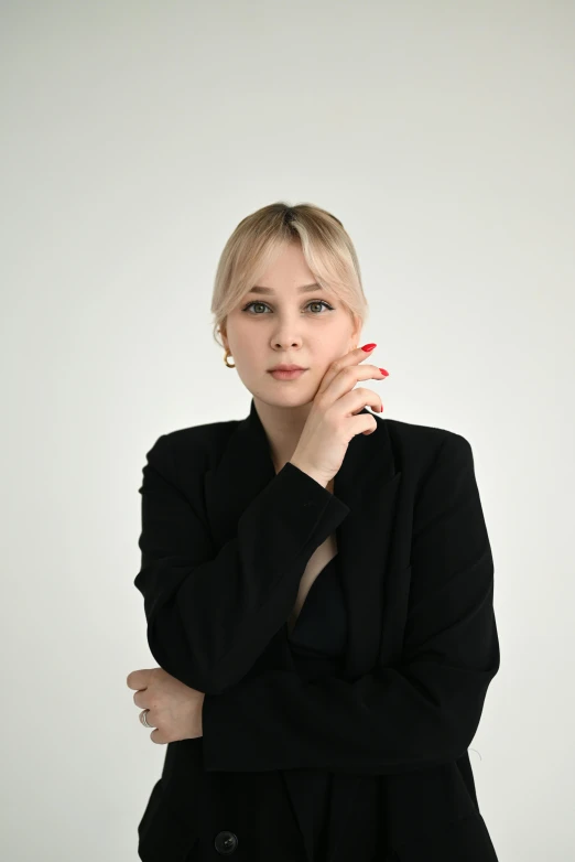 a woman is posing for a picture in front of a white background