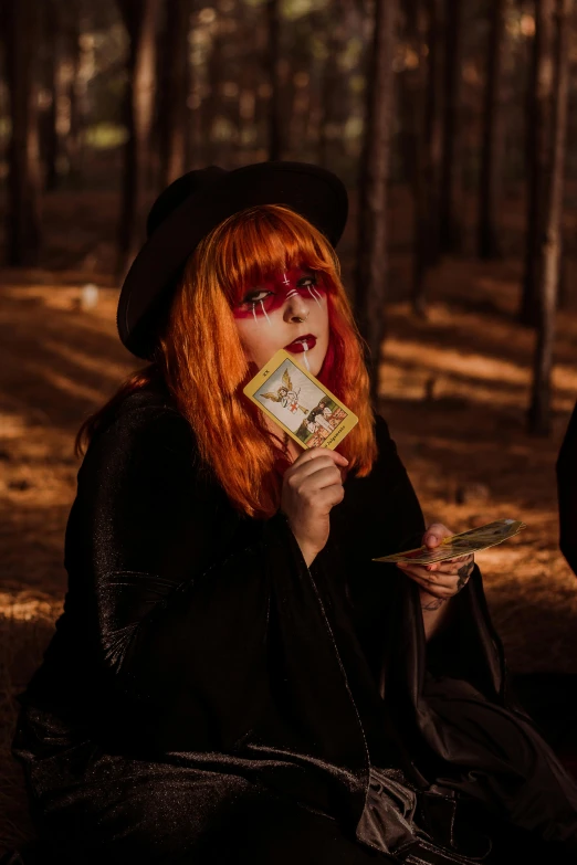 a lady in a witches costume holding a box