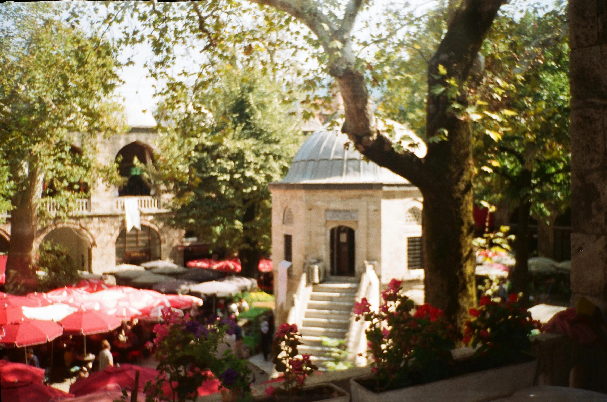 an open courtyard with tables and umbrellas