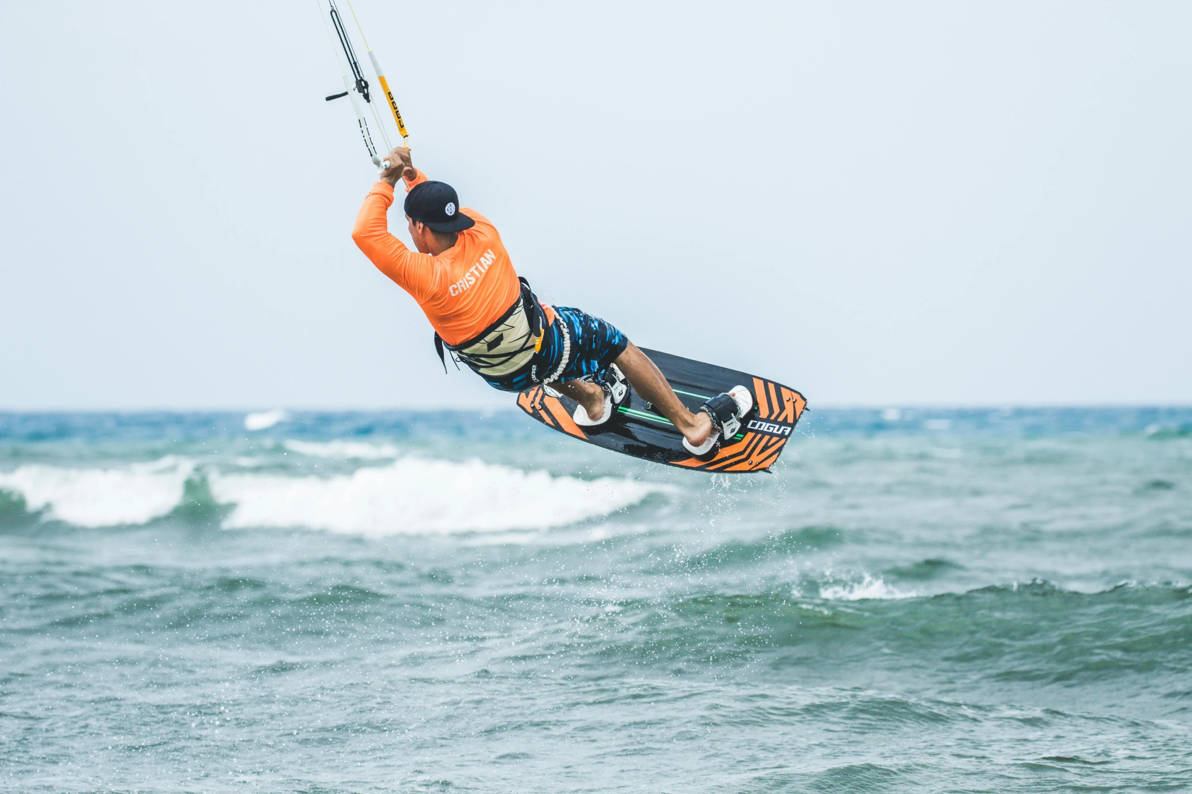 a man on a wake board that is in the air