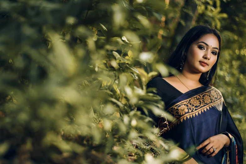 an indian woman posing in the woods
