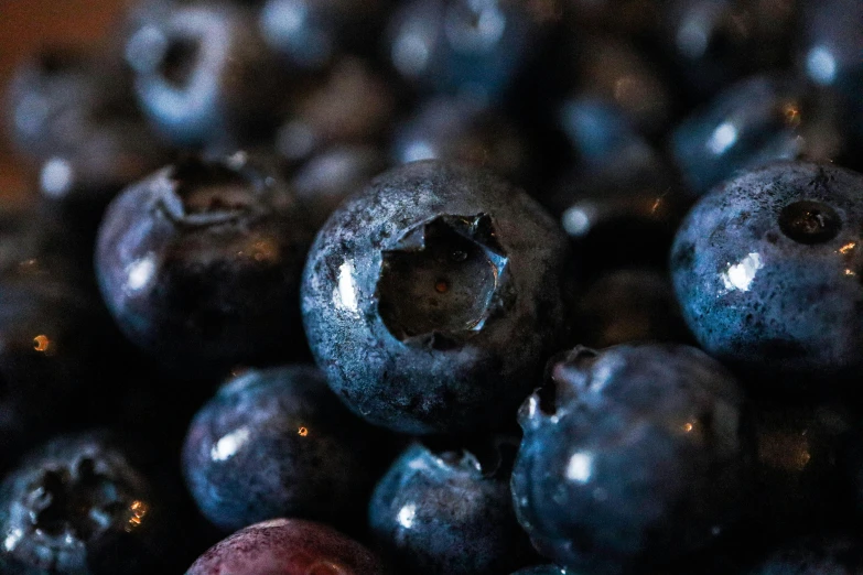 some blueberries are piled up on top of each other