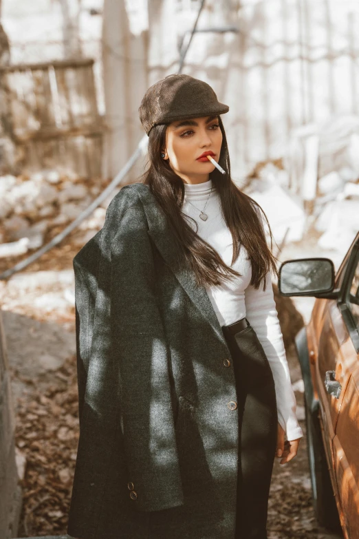 a woman with a cigarette standing next to a car