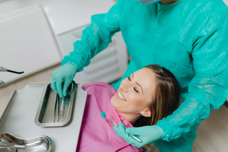 a woman getting her teeth checked with the dental services