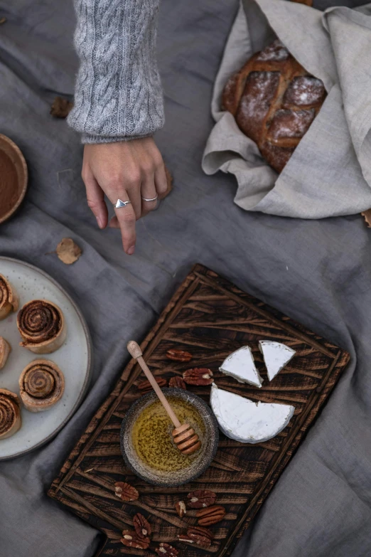 a woman making honey buns with a glass of honey