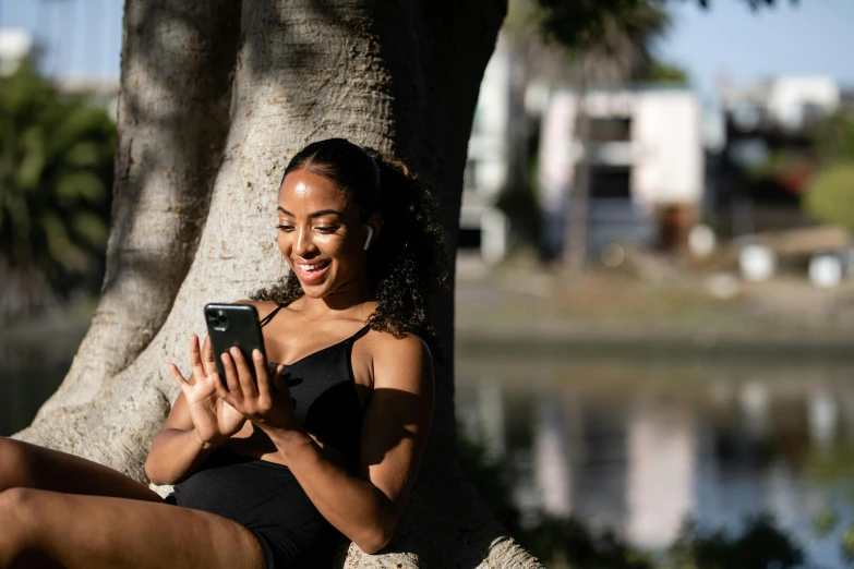 a beautiful young lady texting on her phone