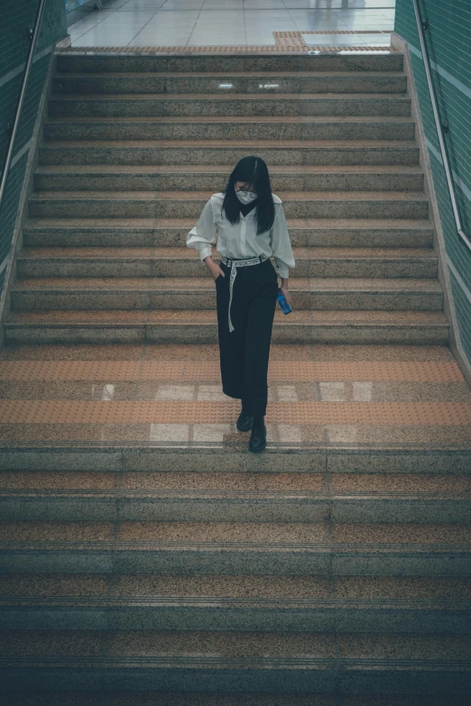 a woman standing on stairs holding an umbrella