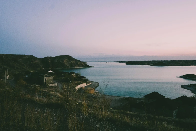 an ocean shore with a house on it