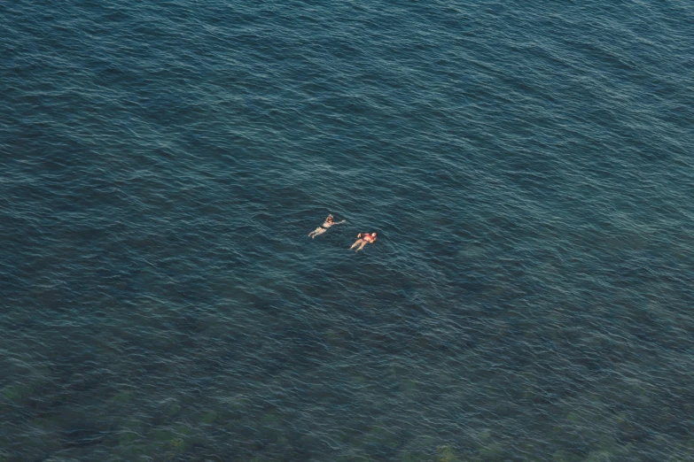 a man and woman in the water on a float