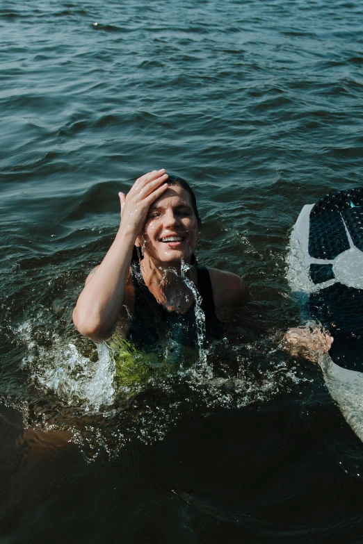 a person in the water on a surfboard