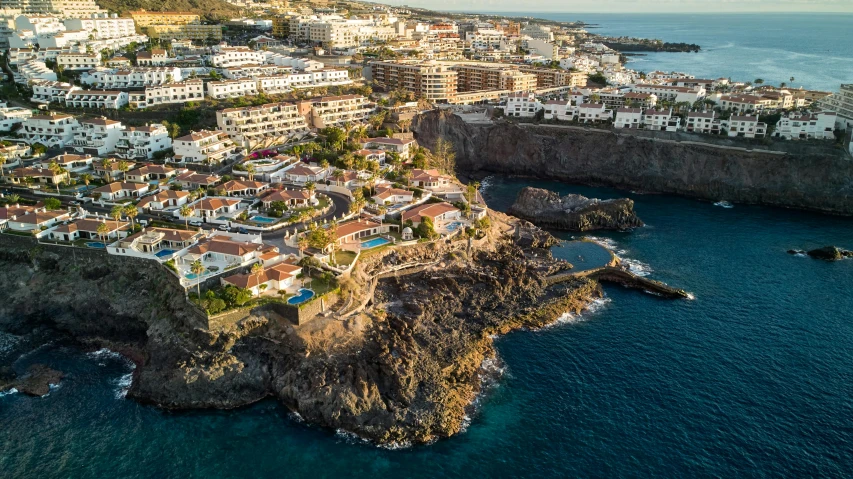 the large houses are on the cliff by the water