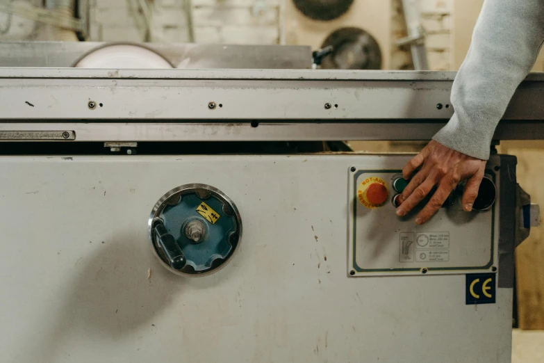 a close up of a person's hand on a machine