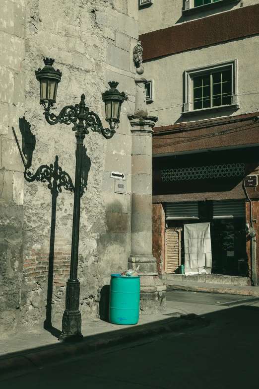 the building with the two light fixtures and blue bucket on it