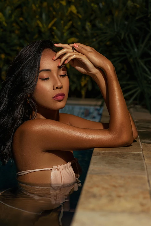 a woman with no  and black hair sitting at a pool